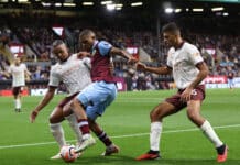 Lyle Foster of Burnley takes on Manuel Akanji and Rodri of Manchester City