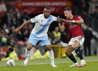 Man United vs Crystal Palace: Jordan Ayew of Crystal Palace holds off Diogo Dalot of Manchester United during the Carabao Cup match